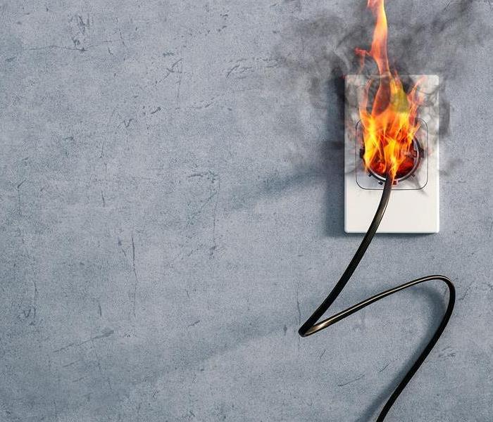 A plug in the wall on fire