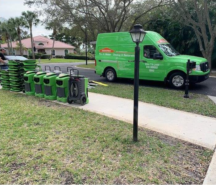 SERVPRO vehicle parked in front of home with equipment